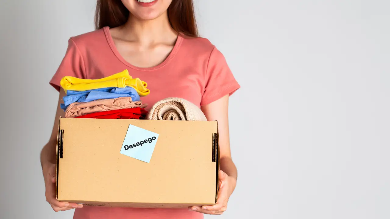 Pessoa segurando uma pequena caixa de lembranças com uma expressão feliz, simbolizando o processo de desapego.