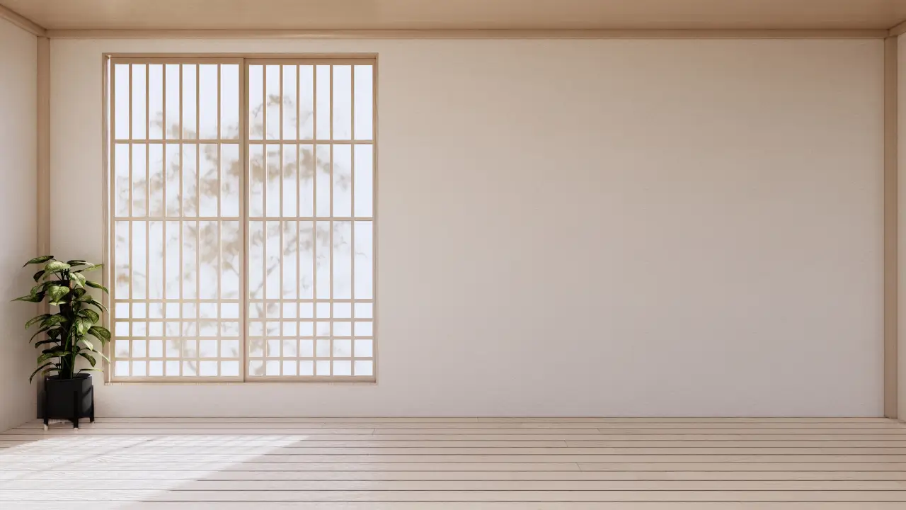 Um canto de uma sala com parede greige, destacando um vaso preto e uma planta verde para mostrar como o contraste quebra a monotonia.