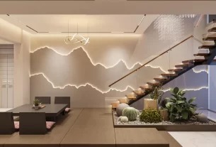 Sala de estar decorada com a cor greige na parede, um sofá branco, almofadas texturizadas e uma mesa de centro de madeira, exemplificando a tendência greige.